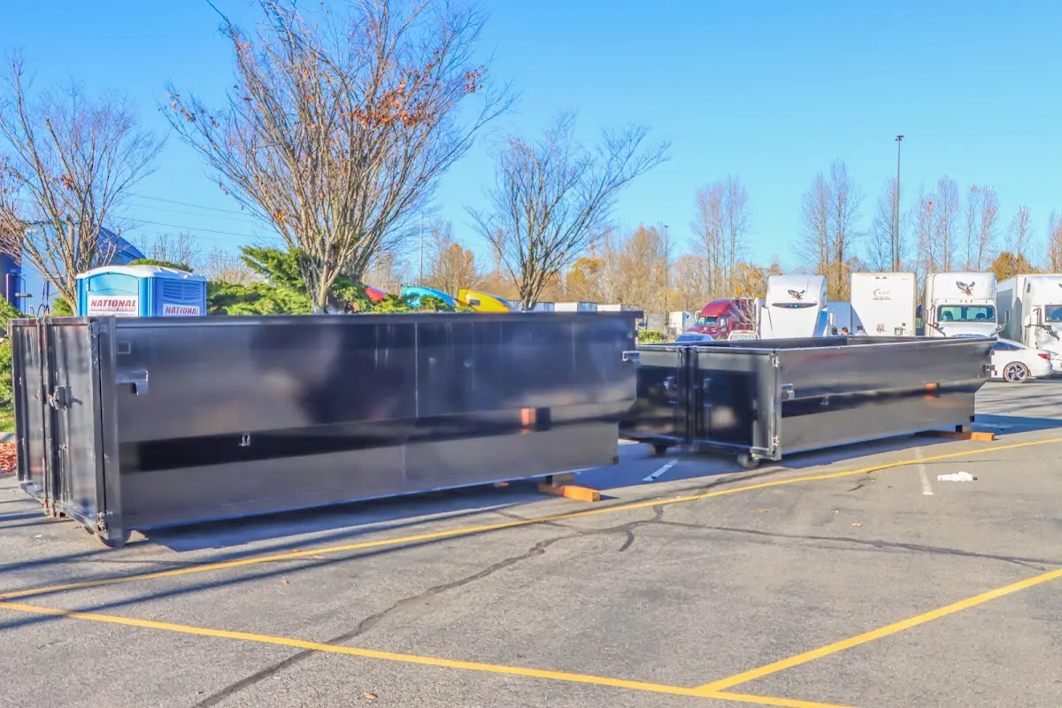 Professional dumpster rental service with roll-off container on residential driveway in Cortez